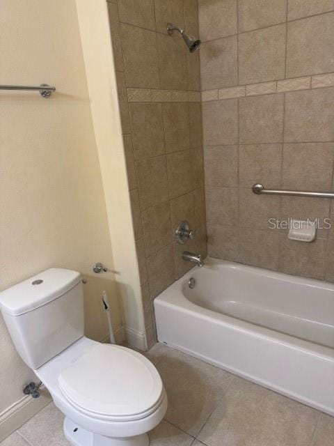 bathroom with shower / bathtub combination, baseboards, toilet, and tile patterned floors