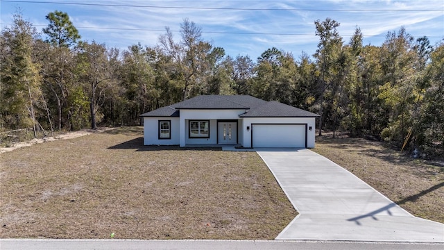 view of front of property featuring a garage, concrete driveway, a front lawn, and stucco siding