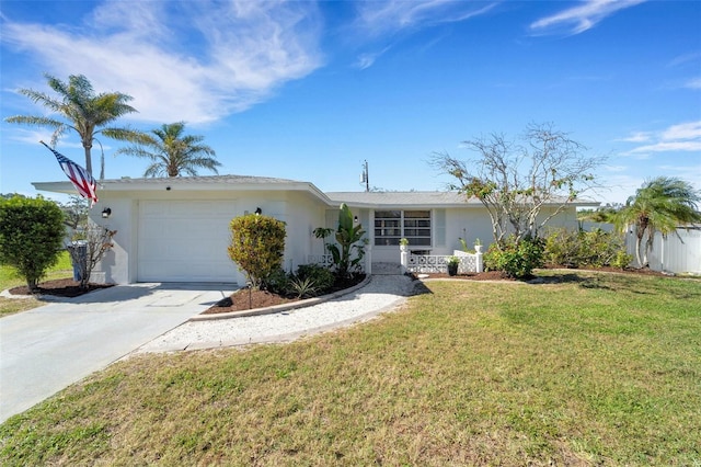 ranch-style house featuring an attached garage, driveway, a front yard, and stucco siding