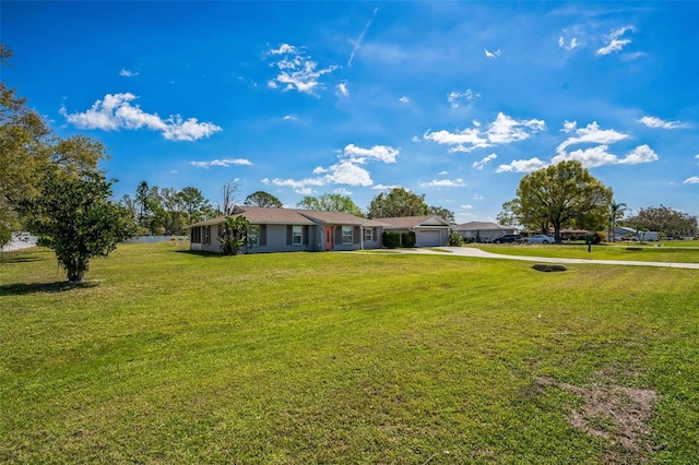 single story home with an attached garage, driveway, and a front lawn