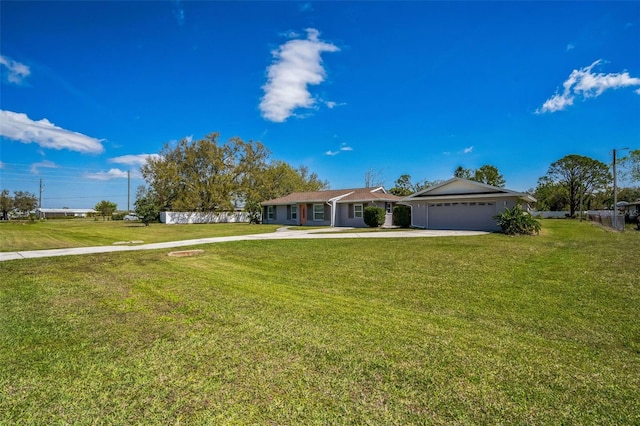 single story home with a front yard, an attached garage, and driveway