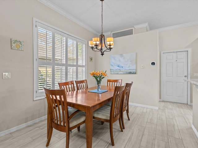 dining area with wood finish floors, visible vents, a notable chandelier, ornamental molding, and baseboards