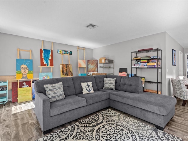 living room with visible vents and wood finished floors