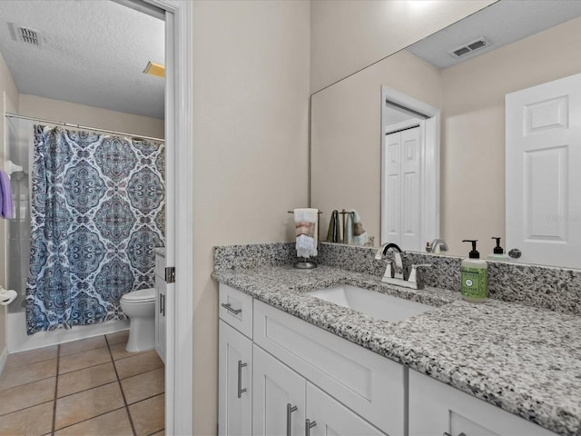 bathroom with tile patterned floors, visible vents, toilet, and vanity