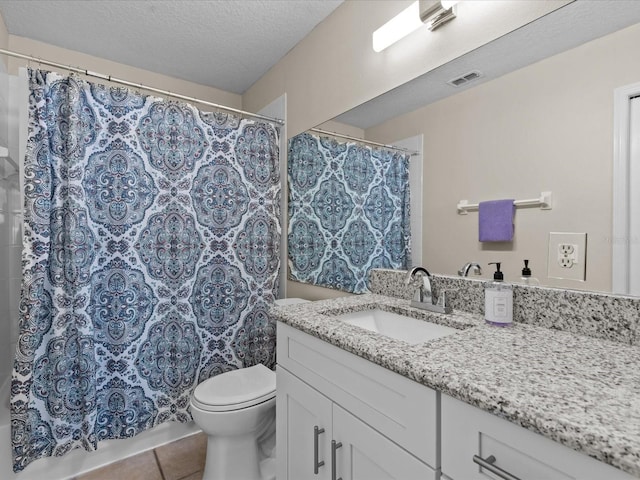 full bathroom featuring visible vents, toilet, vanity, shower / bath combination with curtain, and a textured ceiling