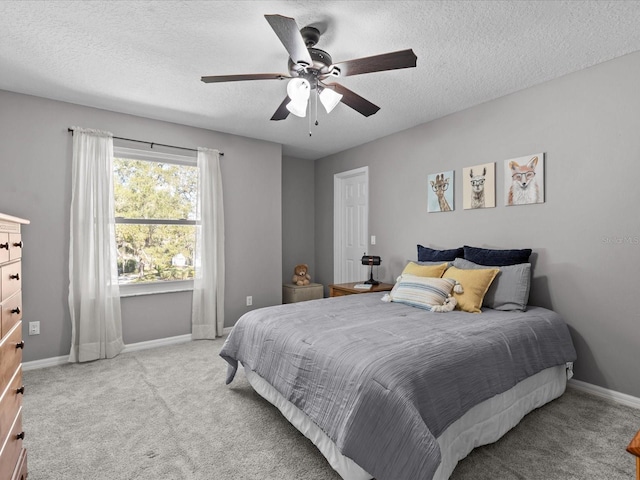 bedroom featuring baseboards, a textured ceiling, ceiling fan, and carpet flooring