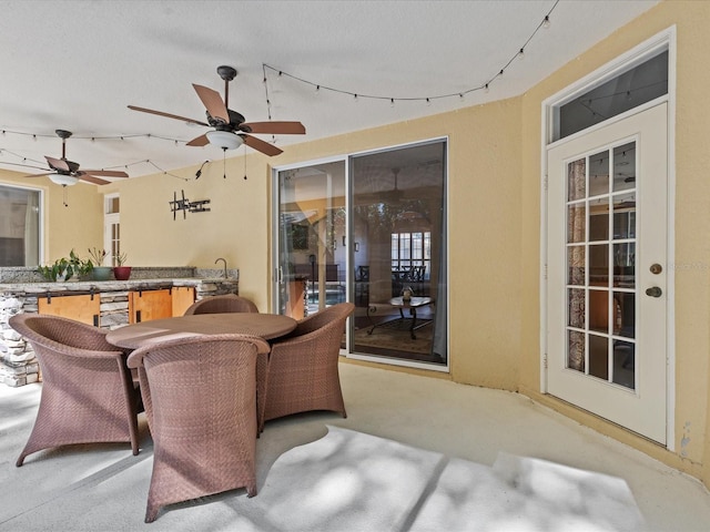 view of patio / terrace featuring outdoor dining space and a ceiling fan