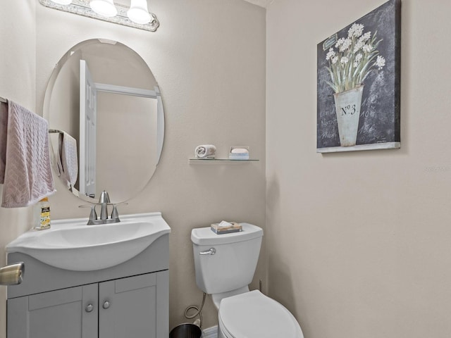 half bath featuring toilet and vanity