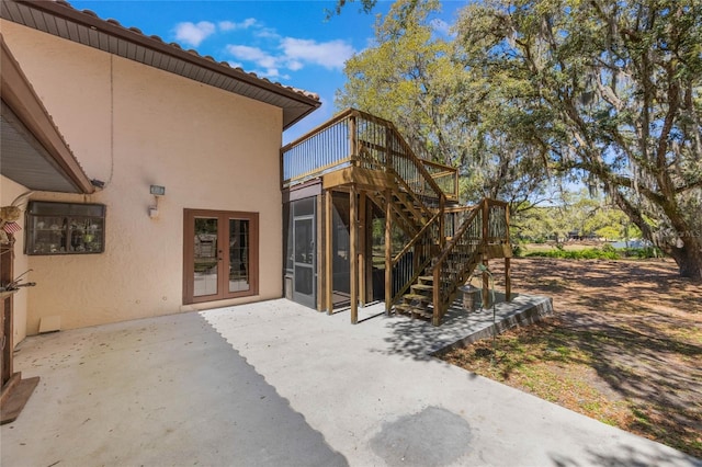 view of patio / terrace with french doors, stairs, and a deck