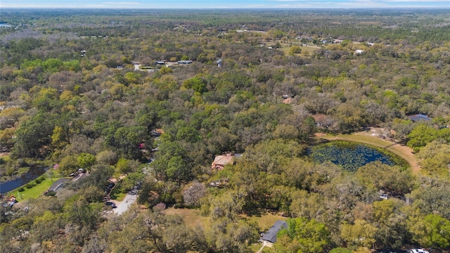 aerial view with a forest view and a water view