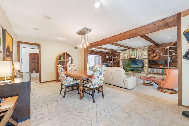 dining room featuring visible vents, beam ceiling, built in features, baseboards, and ceiling fan