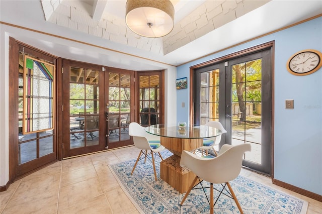 dining room featuring light tile patterned flooring, french doors, and baseboards