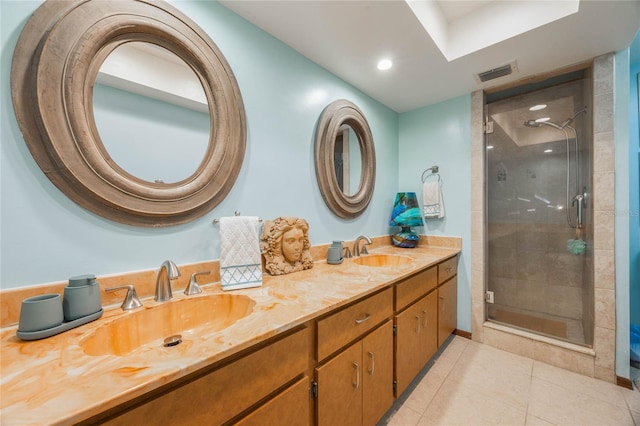 bathroom with tile patterned flooring, a shower stall, visible vents, and a sink