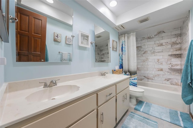 bathroom featuring double vanity, toilet, shower / bath combo with shower curtain, and a sink