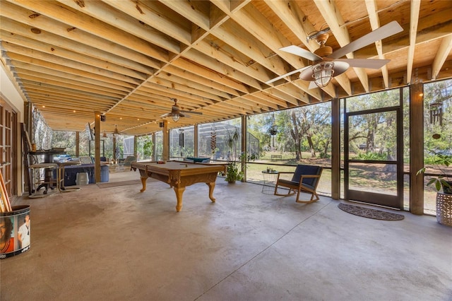 interior space featuring concrete floors, ceiling fan, billiards, and a healthy amount of sunlight