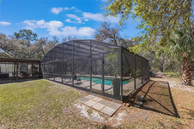 outdoor pool with a yard, a patio, and a lanai