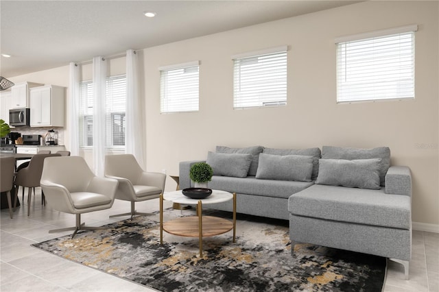 living area featuring light tile patterned floors, recessed lighting, and baseboards