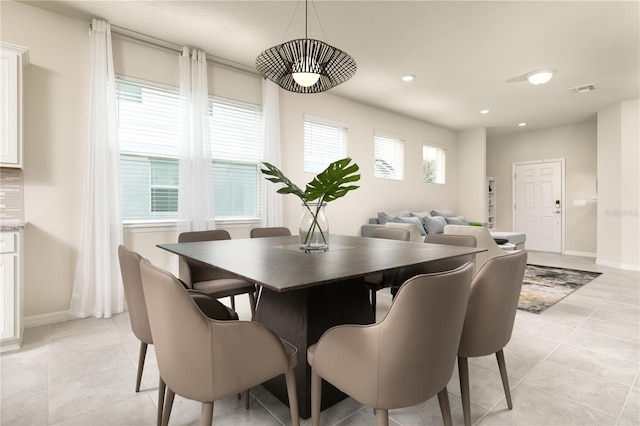 dining space with light tile patterned floors, recessed lighting, visible vents, and baseboards