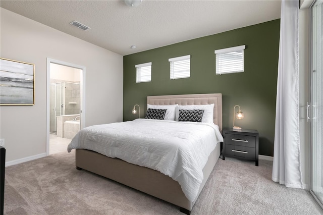 bedroom with baseboards, visible vents, a textured ceiling, carpet flooring, and connected bathroom