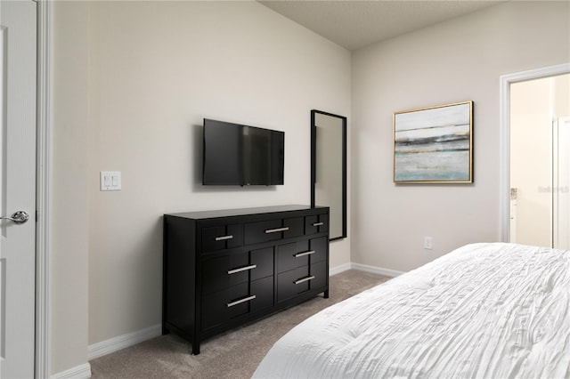 bedroom featuring carpet flooring and baseboards