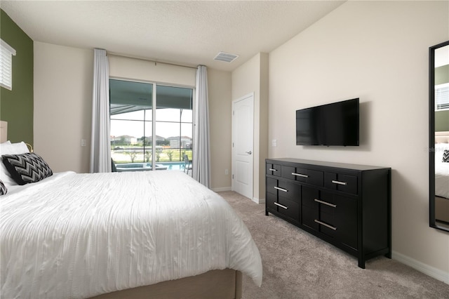 bedroom with visible vents, a textured ceiling, baseboards, light colored carpet, and access to exterior