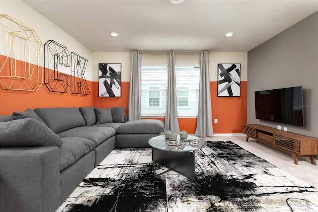 living area with a textured ceiling and carpet flooring