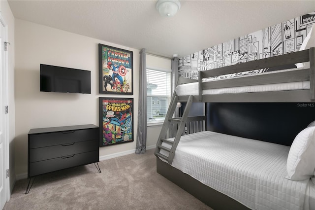 bedroom featuring a textured ceiling, baseboards, and carpet floors