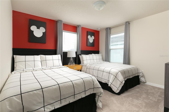 carpeted bedroom with baseboards and a textured ceiling