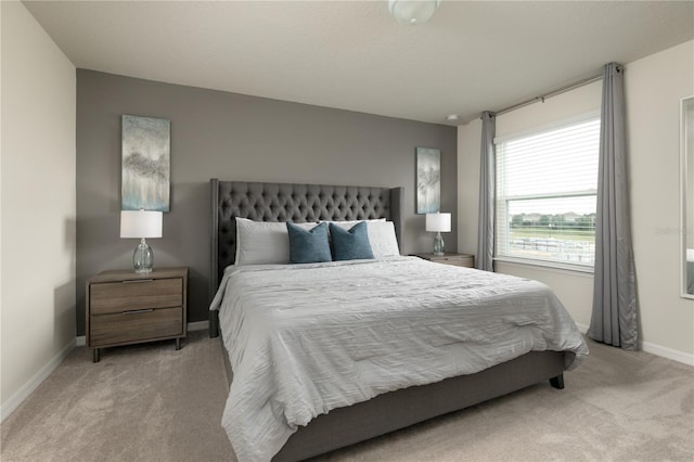 bedroom featuring baseboards and carpet flooring