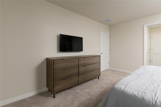 bedroom with visible vents, light colored carpet, and baseboards