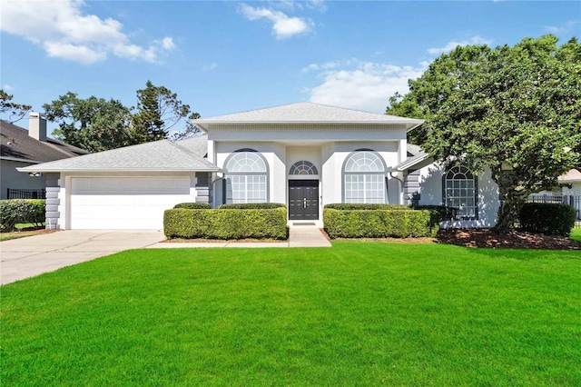 view of front of property featuring roof with shingles, stucco siding, concrete driveway, a front yard, and a garage