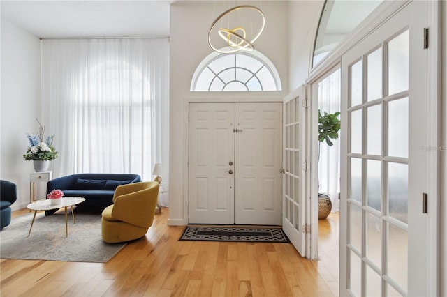 foyer with a chandelier and light wood finished floors