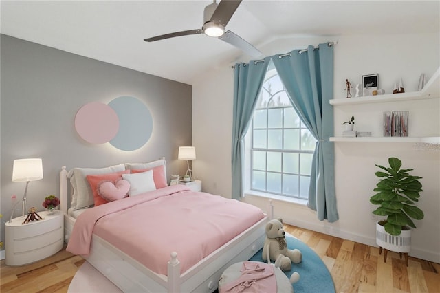 bedroom with vaulted ceiling, ceiling fan, and wood finished floors