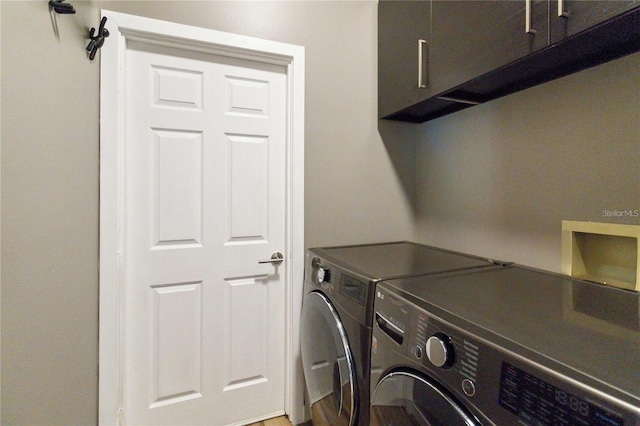 laundry area with cabinet space and independent washer and dryer