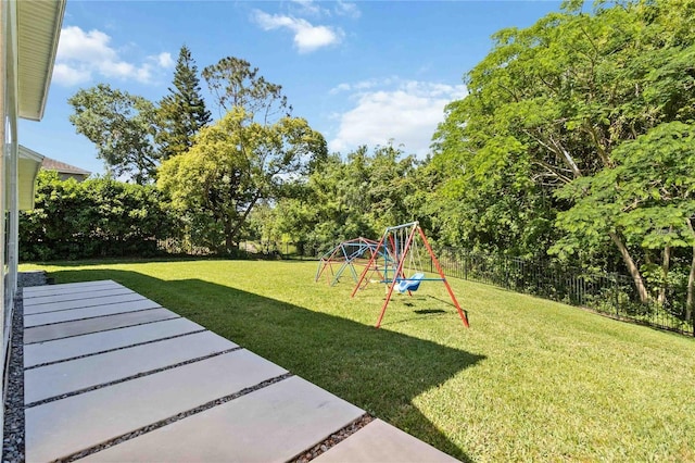 view of yard with a fenced backyard and a playground