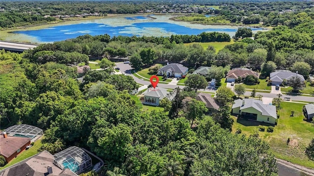 birds eye view of property featuring a water view, a residential view, and a view of trees