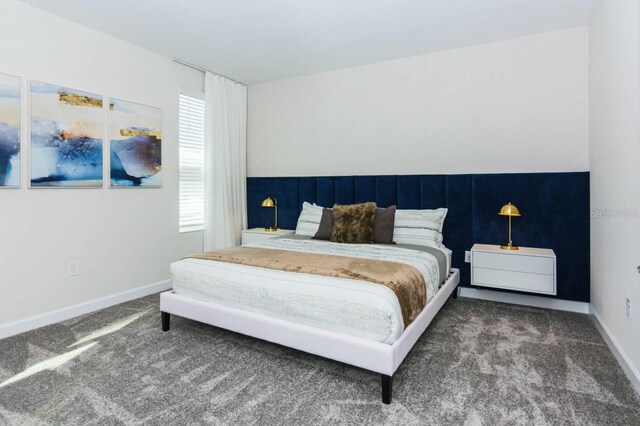 carpeted bedroom featuring baseboards