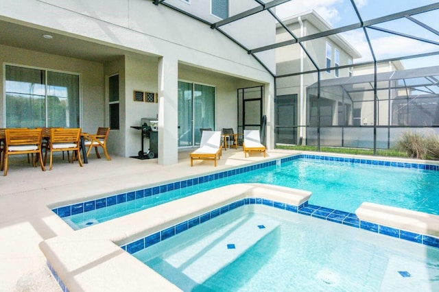 view of swimming pool featuring a pool with connected hot tub, glass enclosure, and a patio