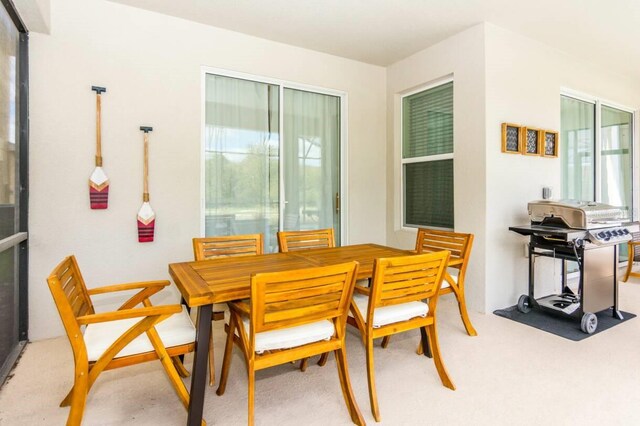 dining area with light colored carpet