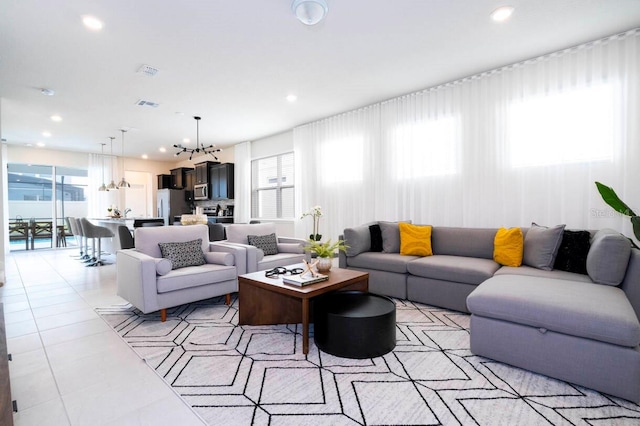 living room with recessed lighting, light tile patterned flooring, plenty of natural light, and visible vents