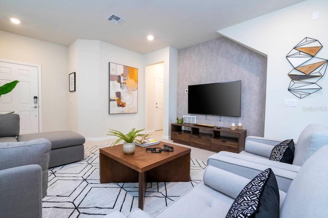 living room featuring baseboards, visible vents, and recessed lighting