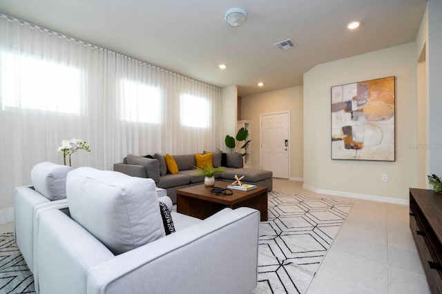 living room featuring baseboards, visible vents, and recessed lighting