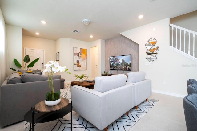 living room with recessed lighting, visible vents, baseboards, and stairs