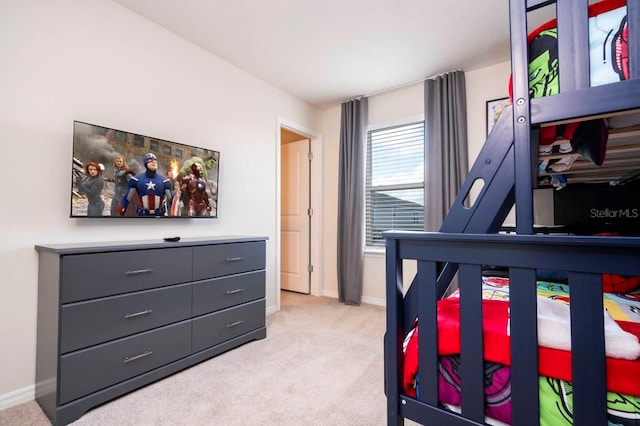 bedroom with light carpet and baseboards