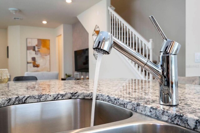 room details with light stone counters and recessed lighting