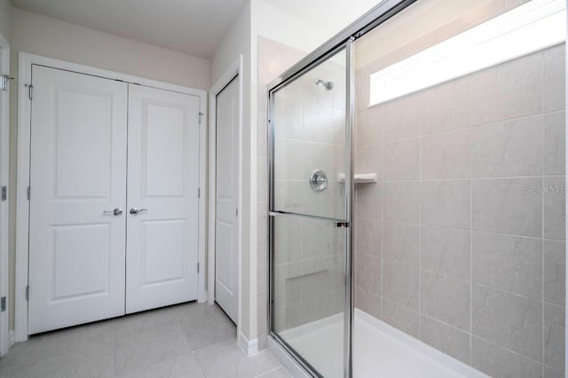 full bathroom featuring a stall shower and tile patterned floors