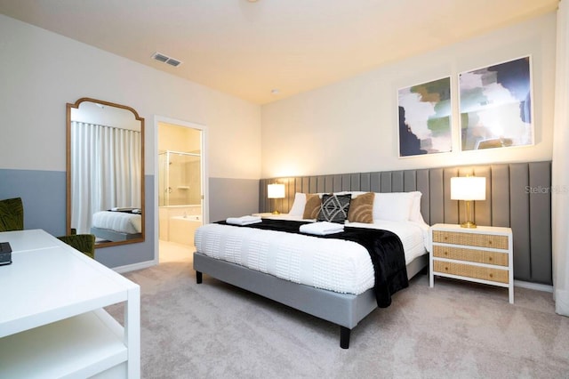 bedroom featuring carpet, ensuite bath, and visible vents