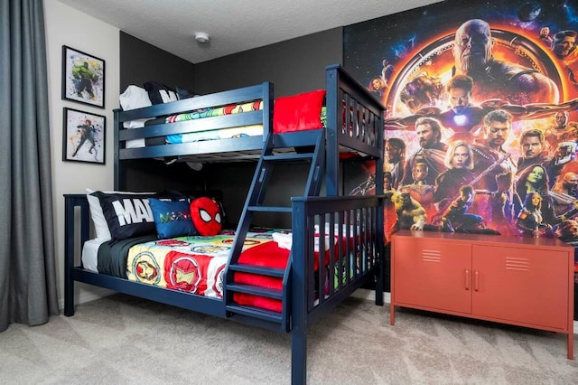 bedroom with carpet floors and a textured ceiling