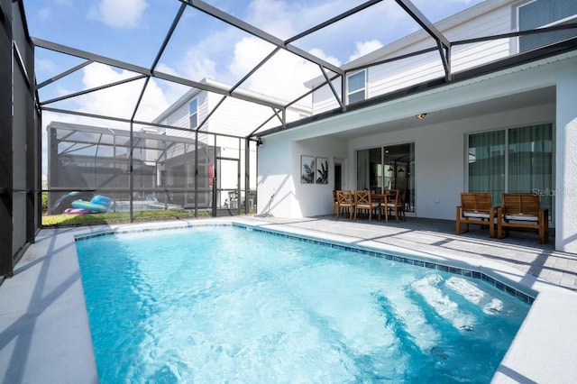 outdoor pool with a lanai, a patio area, and outdoor dining area