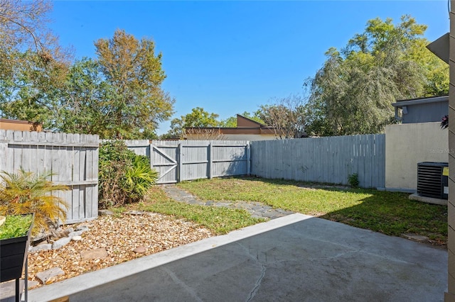 view of yard featuring a patio, central air condition unit, and a fenced backyard